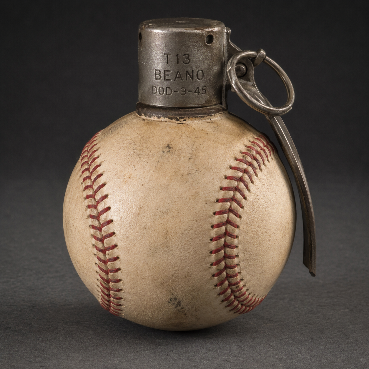 Beano Balling by Damon DeWitt - assemblage pairing a baseball with a grenade pin, from the America's Favorite Pastime series.